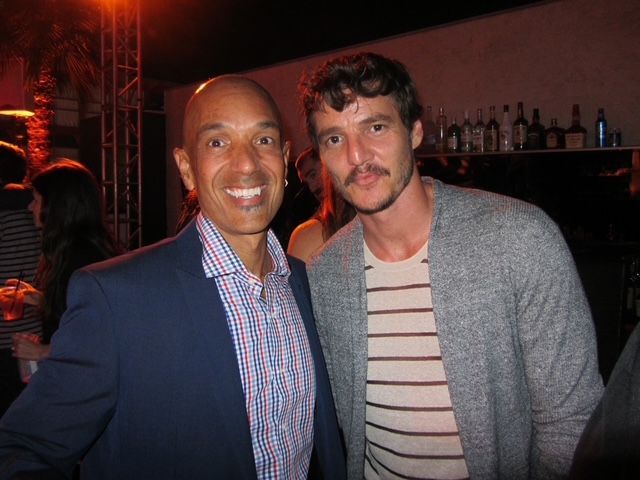 Two men are posing for a picture together at a party.