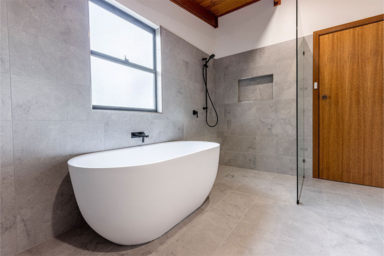 A bathroom with a bathtub and a walk in shower.
