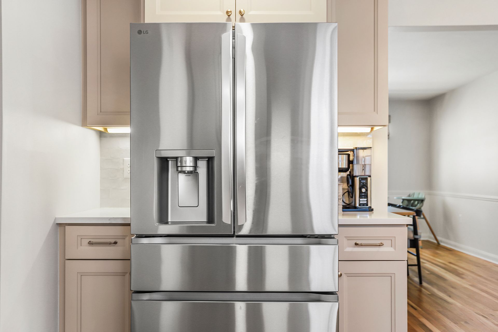 Stainless steel refrigerator with water and ice dispenser in a bright kitchen