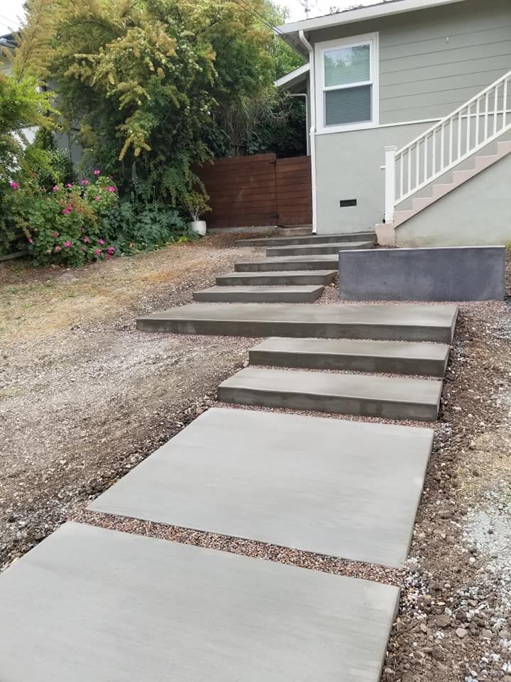 A set of concrete steps leading up to a house.