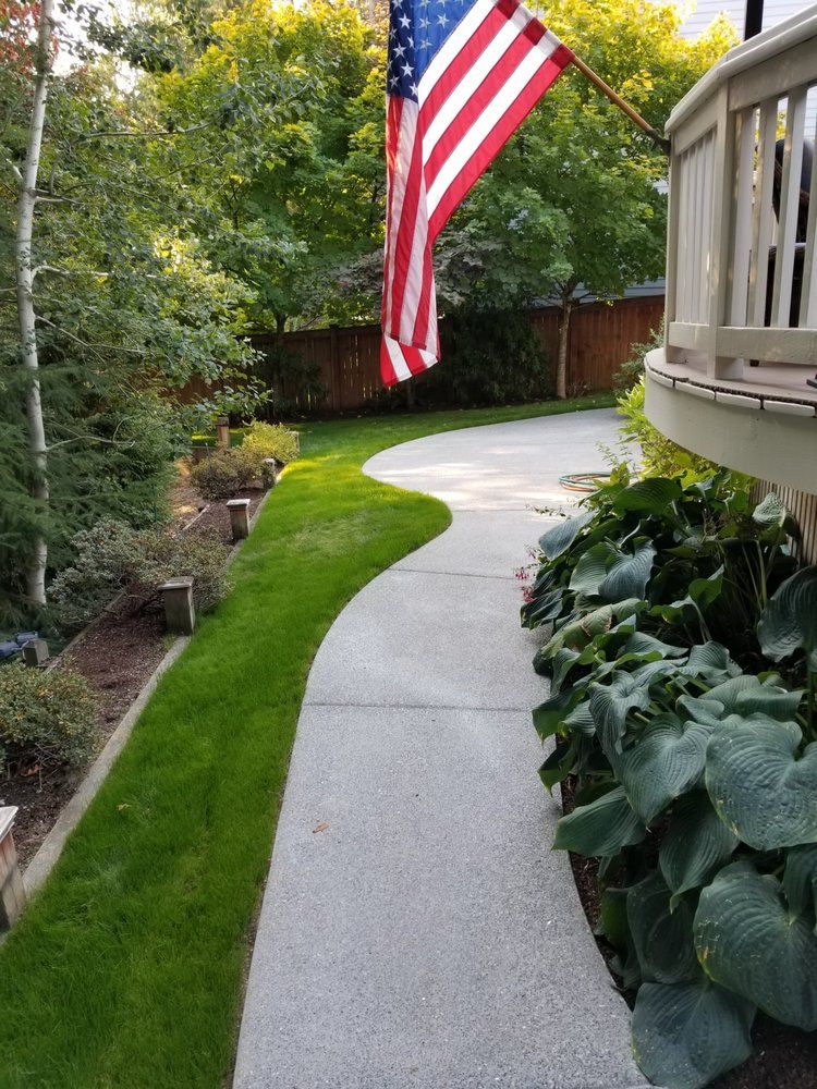 A walkway with an american flag hanging from the side of it