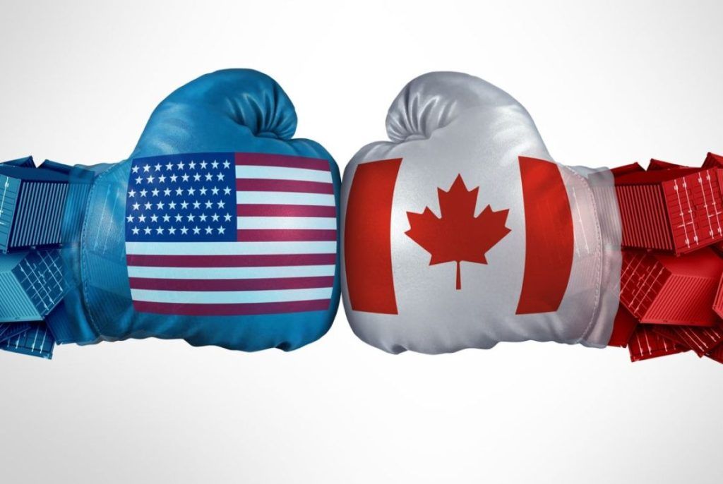 Boxing gloves with U.S. and Canadian flags punching together on a white background