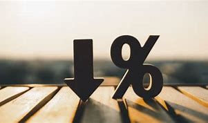 Black downward arrow and percent symbol standing on a wooden surface with blurred background