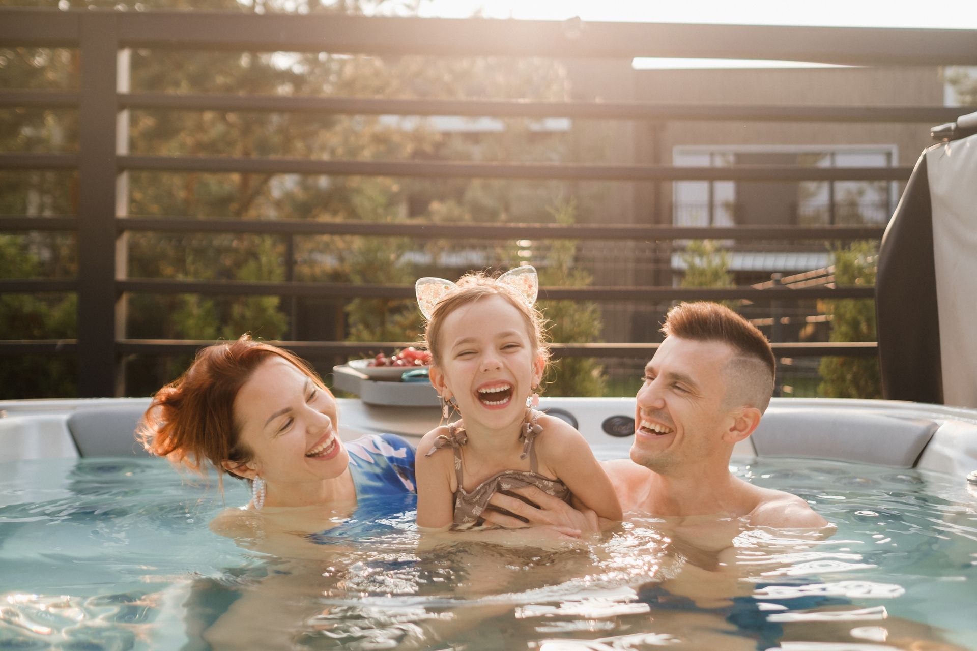 A family is having fun in a hot tub.