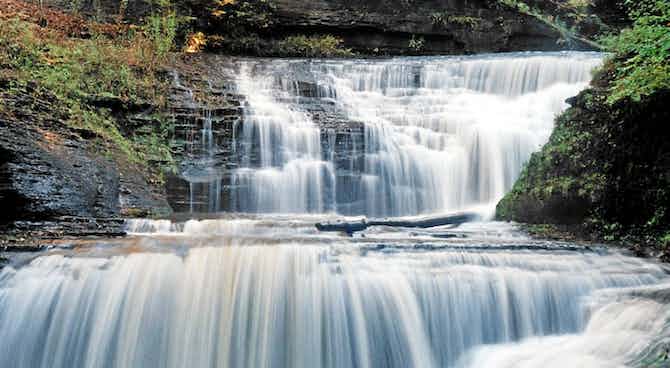 Beautiful waterfall with moss and rocks covered with flowing