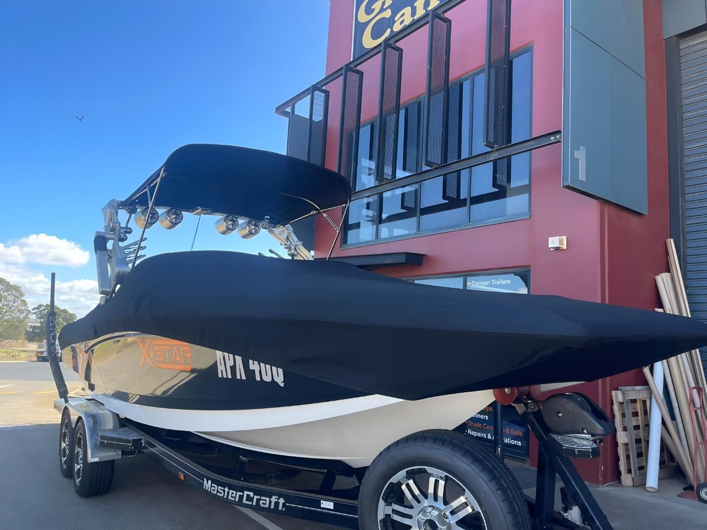 Boat With a Black Cover — Glenvale Canvas Pty Ltd in Wilsonton, QLD