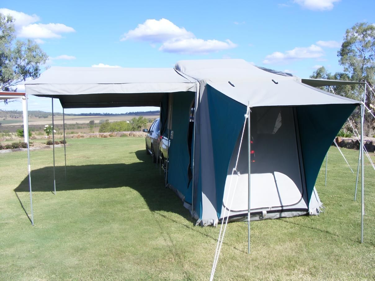 Tent is Set Up in a Grassy Field Next to a Car — Glenvale Canvas Pty Ltd in Wilsonton, QLD