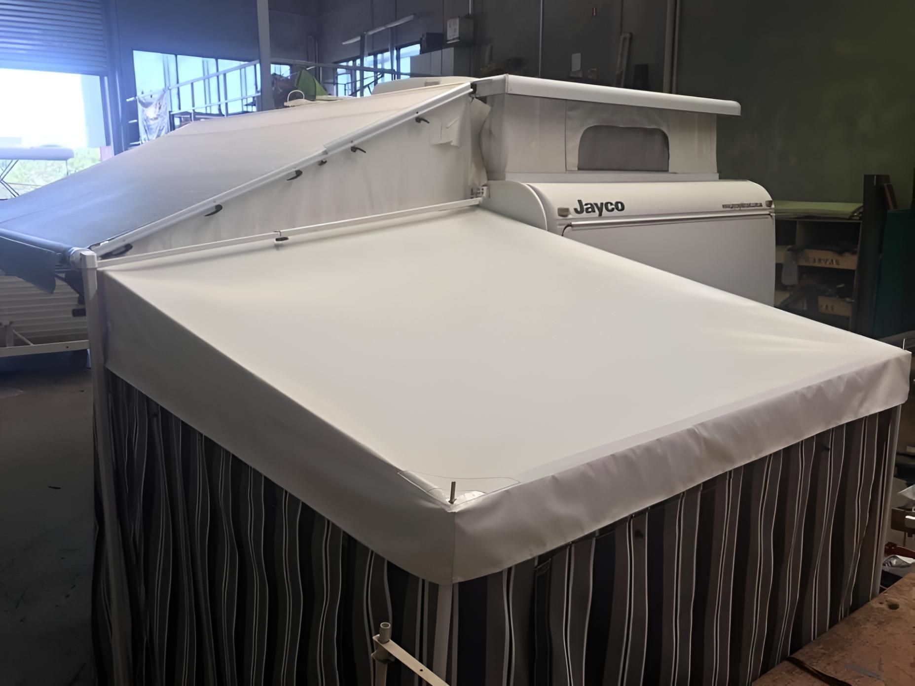 White Awning is Sitting on Top of a Camper — Glenvale Canvas Pty Ltd in Wilsonton, QLD