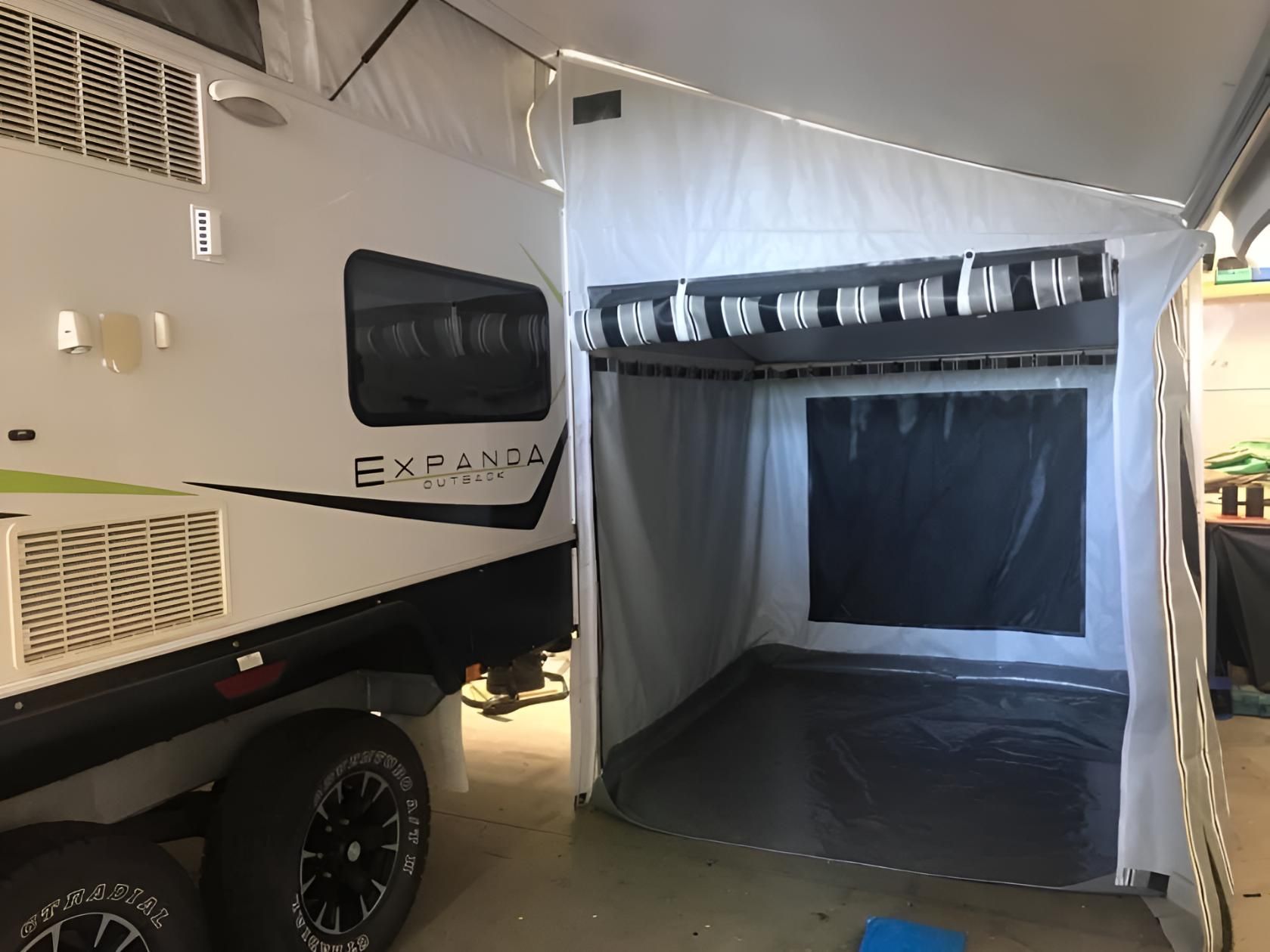 White Rv is Parked in a Garage With a Tent Attached — Glenvale Canvas Pty Ltd in Wilsonton, QLD