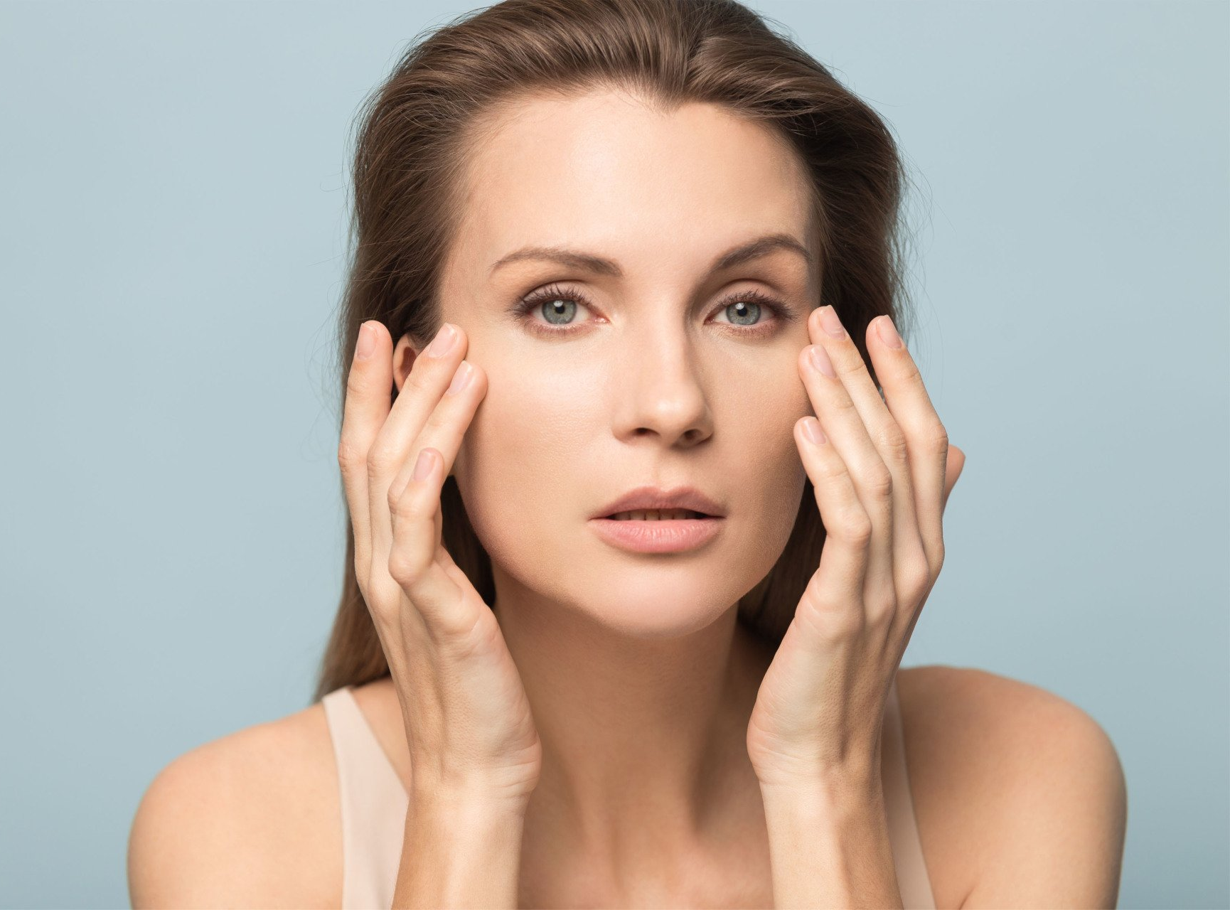 mature woman touches face