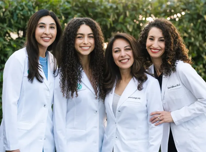 four dermatologists in white lab coats