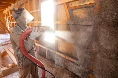 Professional installing spray foam insulation by Foam Insulation Solution in Yakima WA inside a wood structure