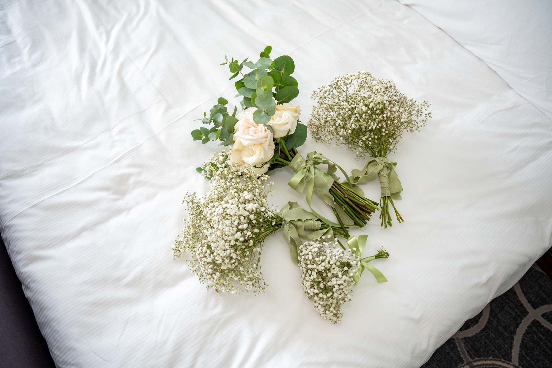 A bunch of flowers are laying on a bed.