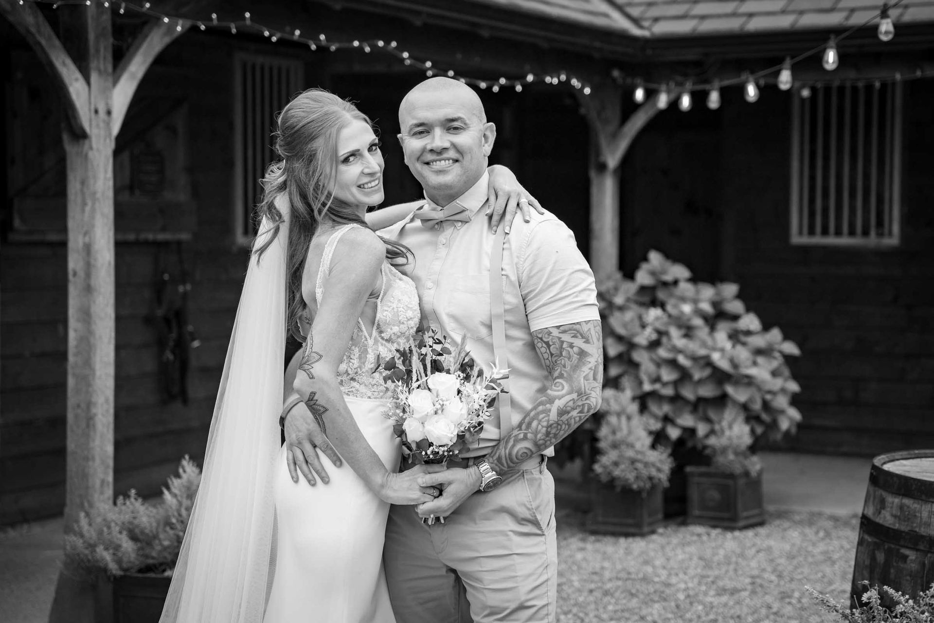 A black and white photo of a bride and groom posing for a picture.