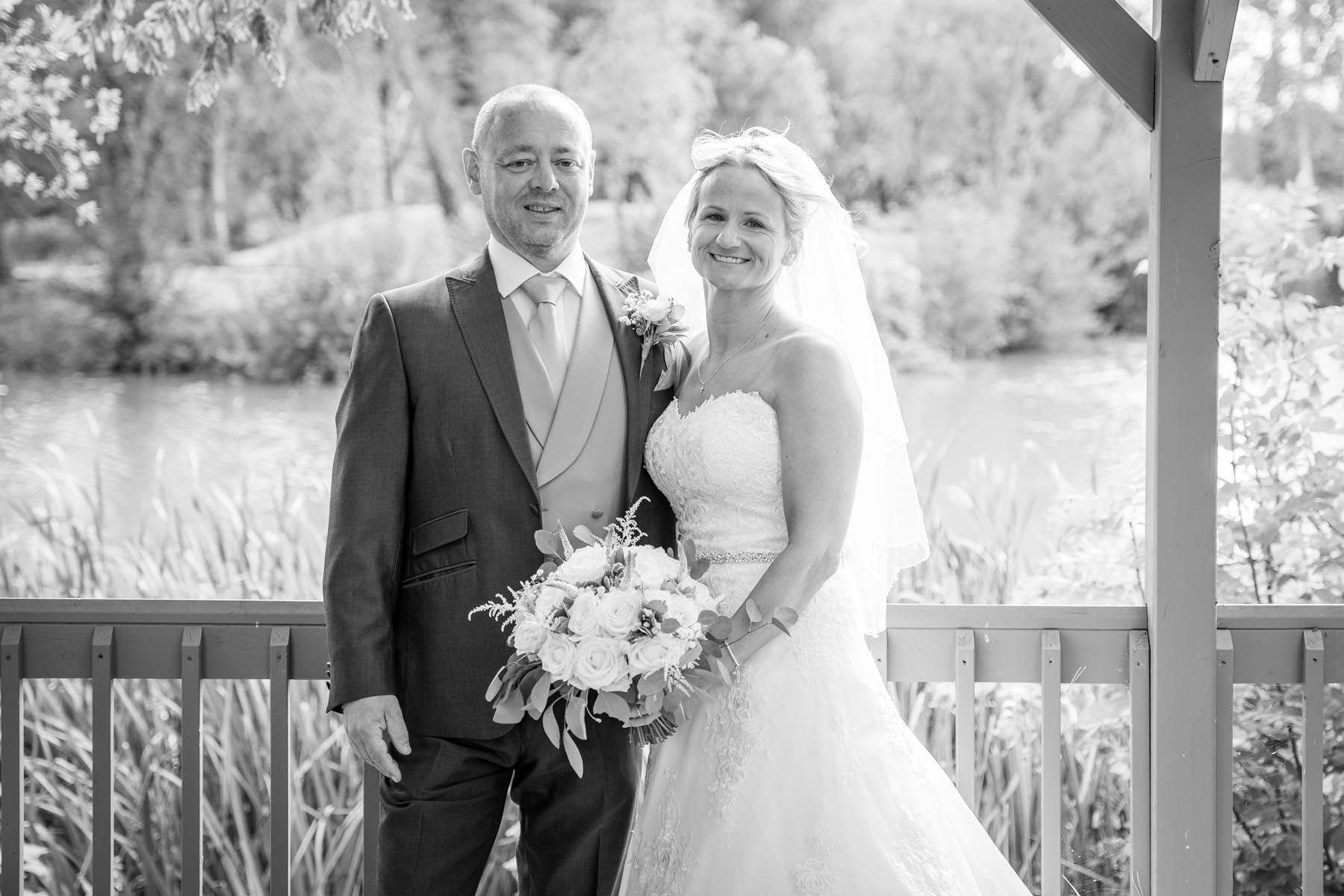 A black and white photo of a bride and groom posing for a picture.
