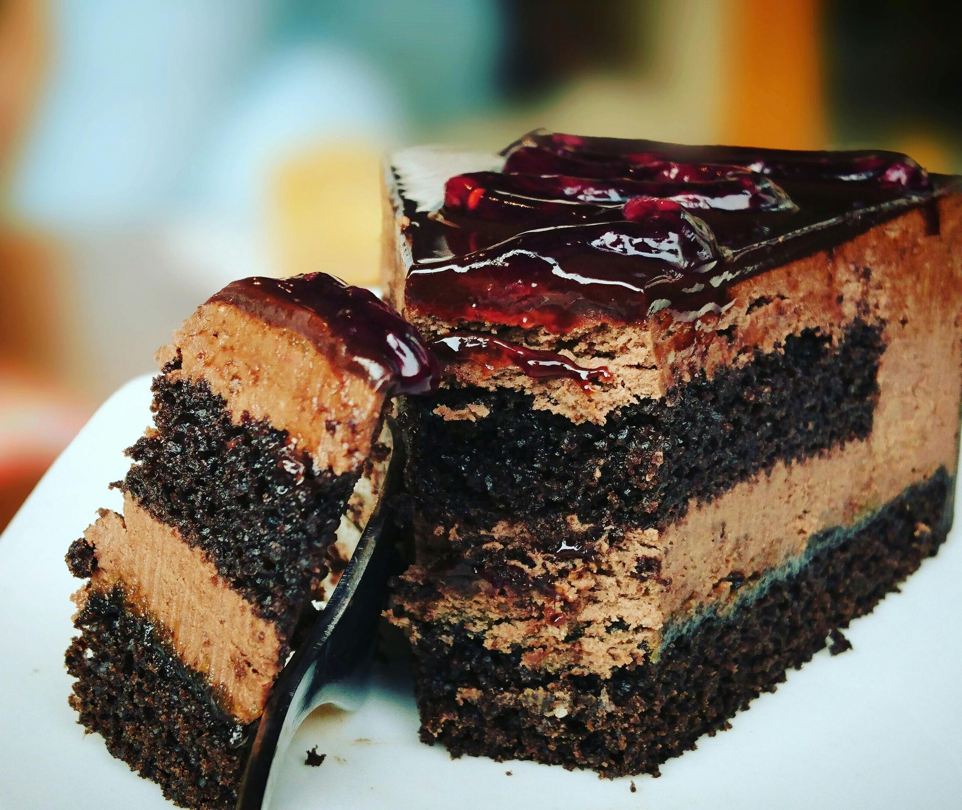 A slice of chocolate cake with a bite taken out of it