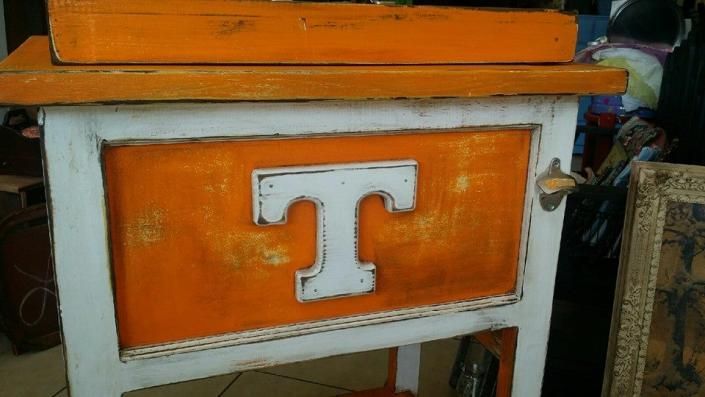 Orange-and-white cabinet with a large white “T” on the front
