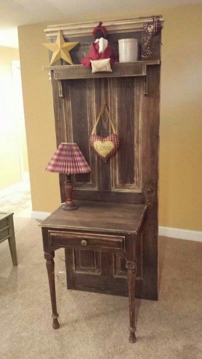 Rustic wooden hall table with mirror shelf, star decor, heart ornament, and small checkered lamp.