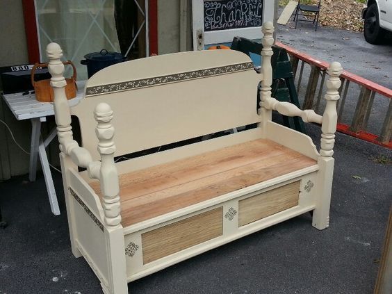 Beige wooden bench with woven storage basket outdoors on a patio.
