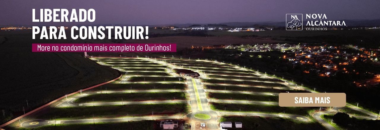 banner Uma vista aérea de uma cidade à noite com uma placa que diz liberado para construir