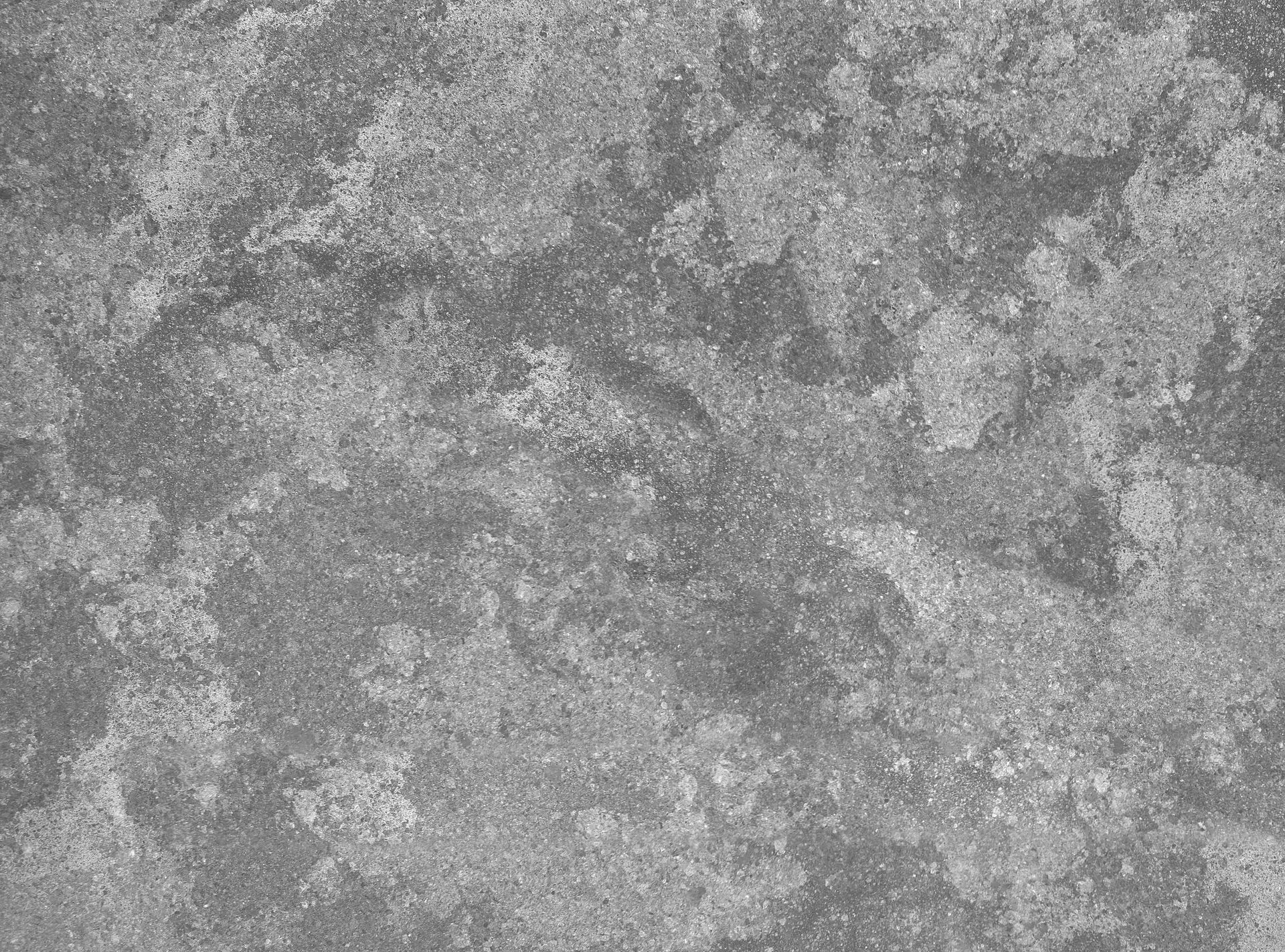 Gray textured stone or concrete surface with a mottled, marbled pattern