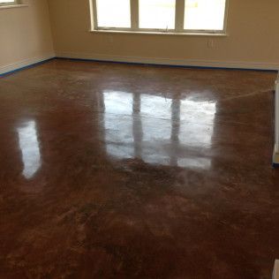 Empty room with glossy dark wood floor and windows reflecting light