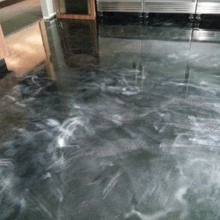 Shiny dark floor with white marbled streaks in an indoor room