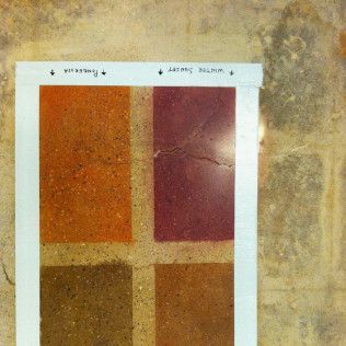 Abstract four-panel color chart with orange, red, and brown squares on a light background
