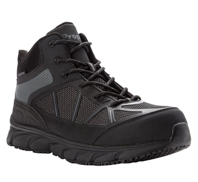 A pair of black safety shoes with a rubber sole on a white background.