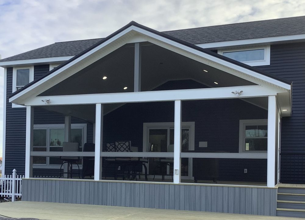 A large house with a screened in porch and stairs