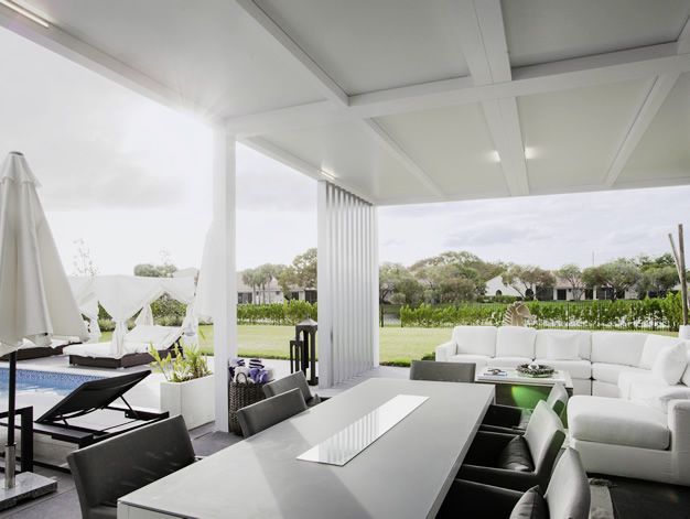 A patio with a table and chairs and an umbrella