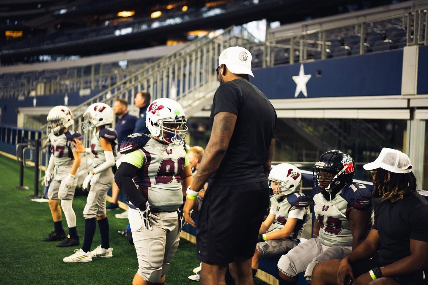 TCP coach working with youth football athletes on the field