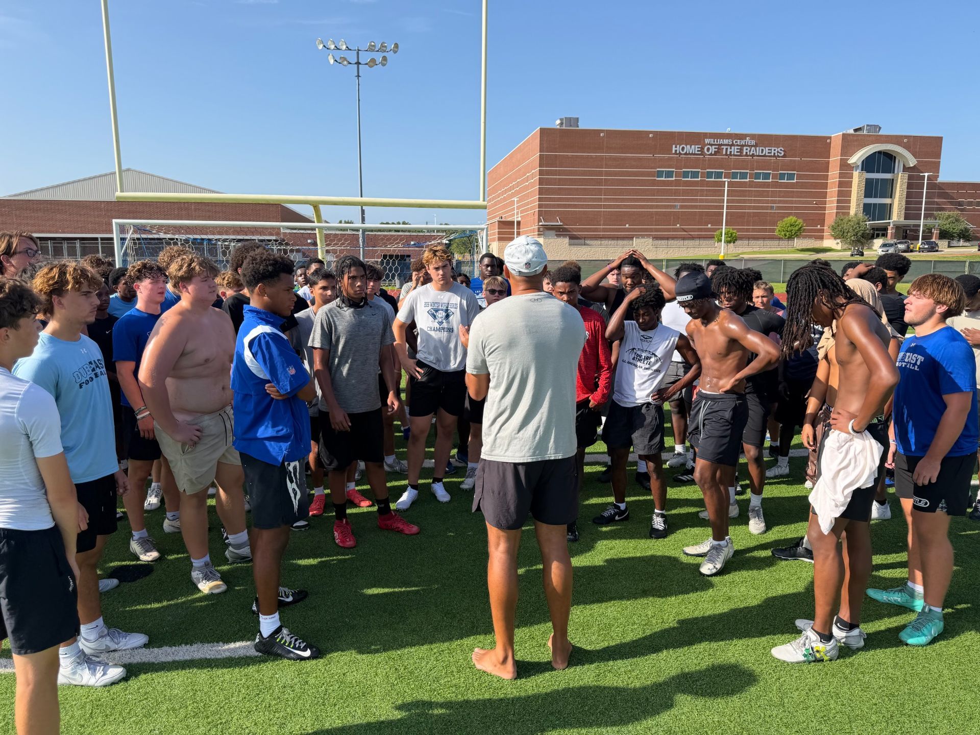 Athletes gathered with their coach during Wylie East training