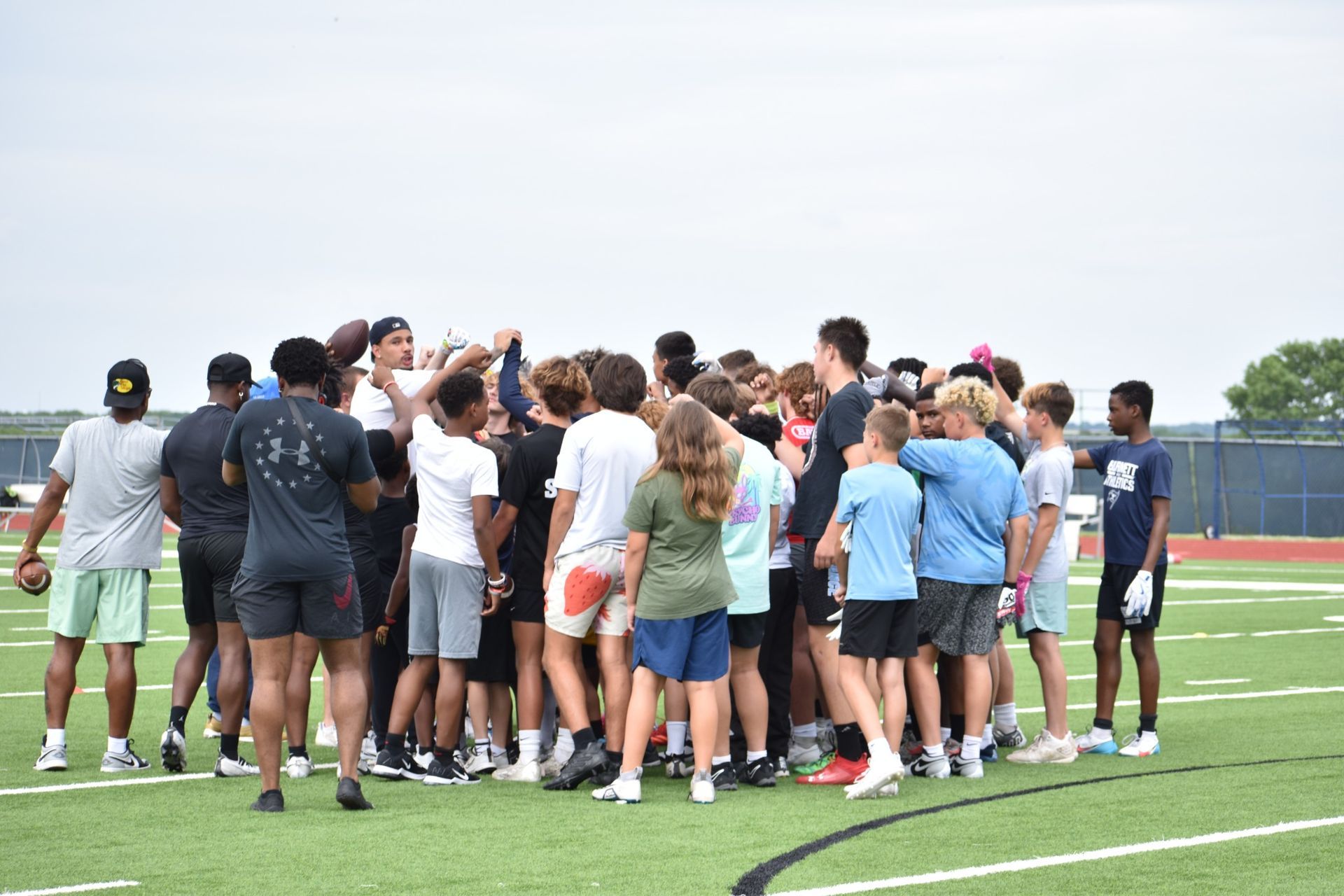 Athletes coming together in a team training huddle with The Circle Performance