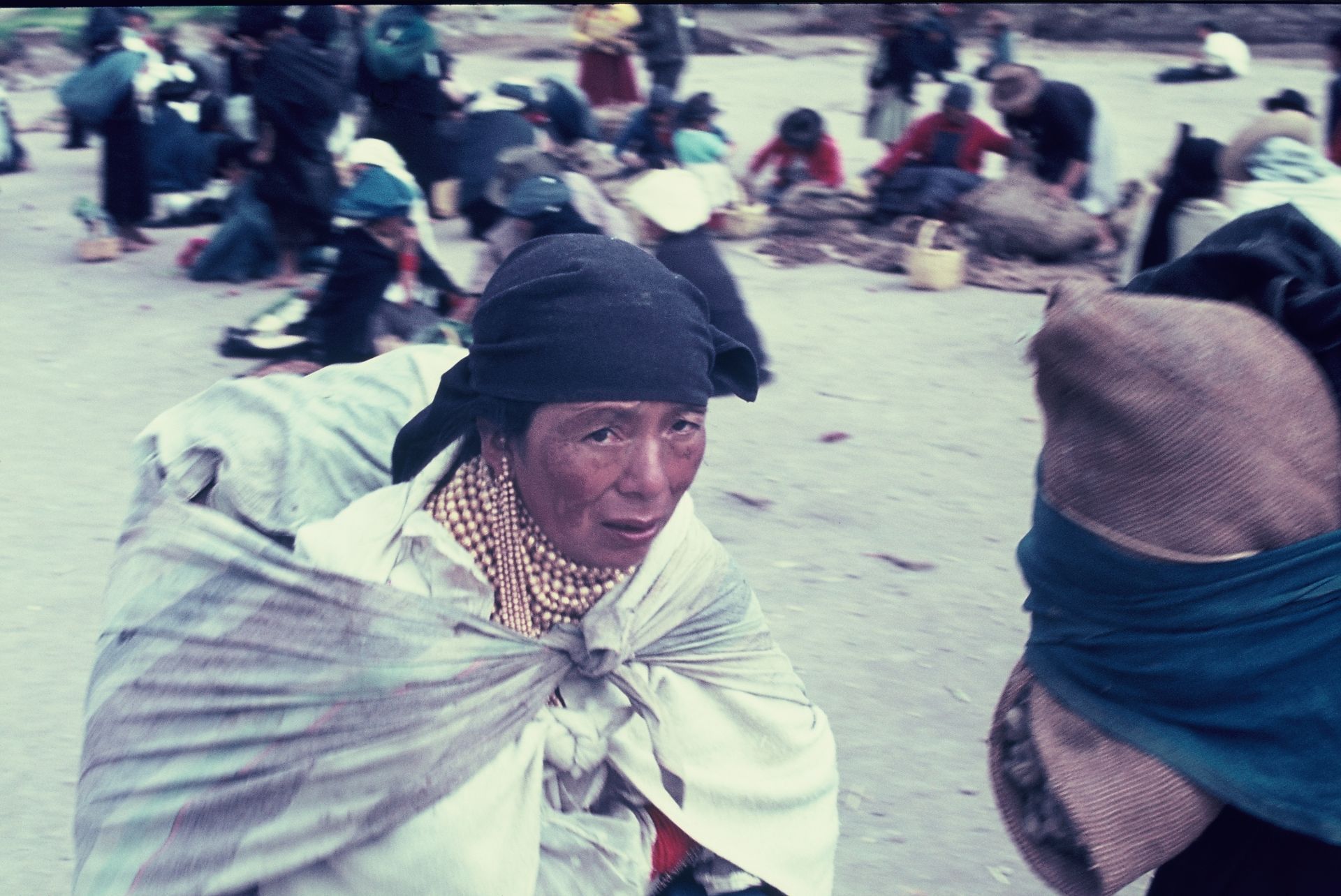 A woman wearing a black head scarf is standing next to another woman