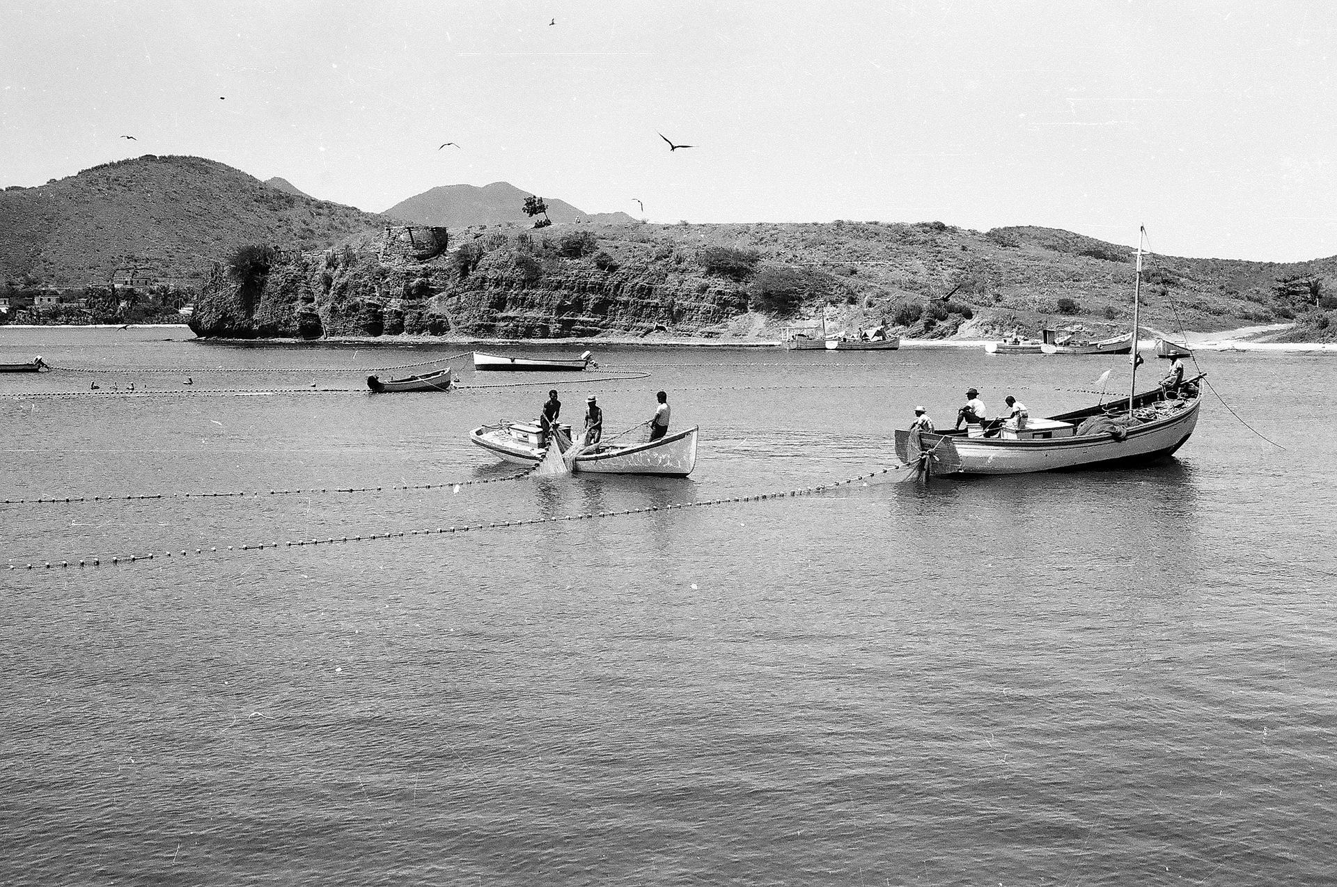 A black and white photo of boats in the water
