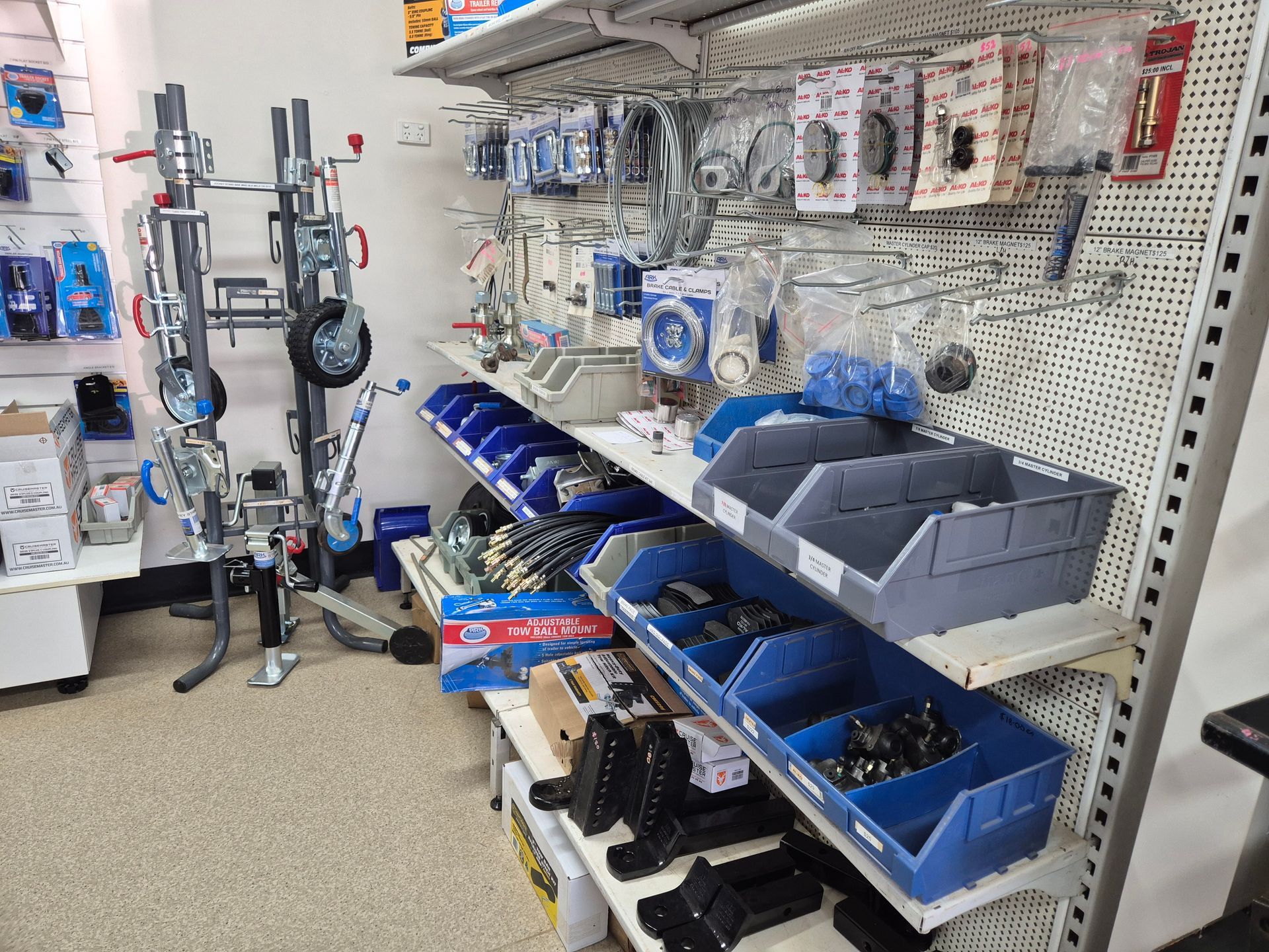 A Store Shelf Filled with Lots of Blue Bins and Boxes — Centre Trailer Sales In Alice Springs, NT