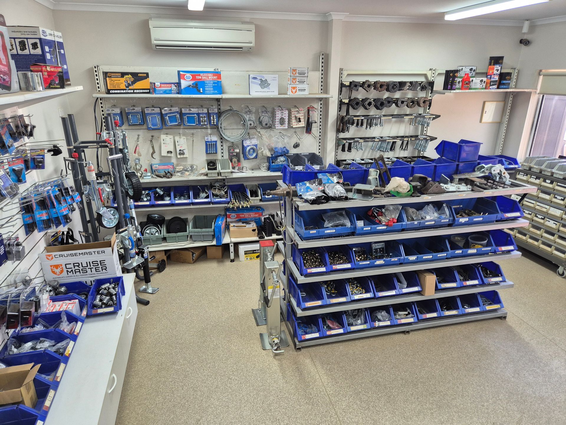 A Store Filled with Lots of Blue Bins and Shelves — Centre Trailer Sales In Alice Springs, NT