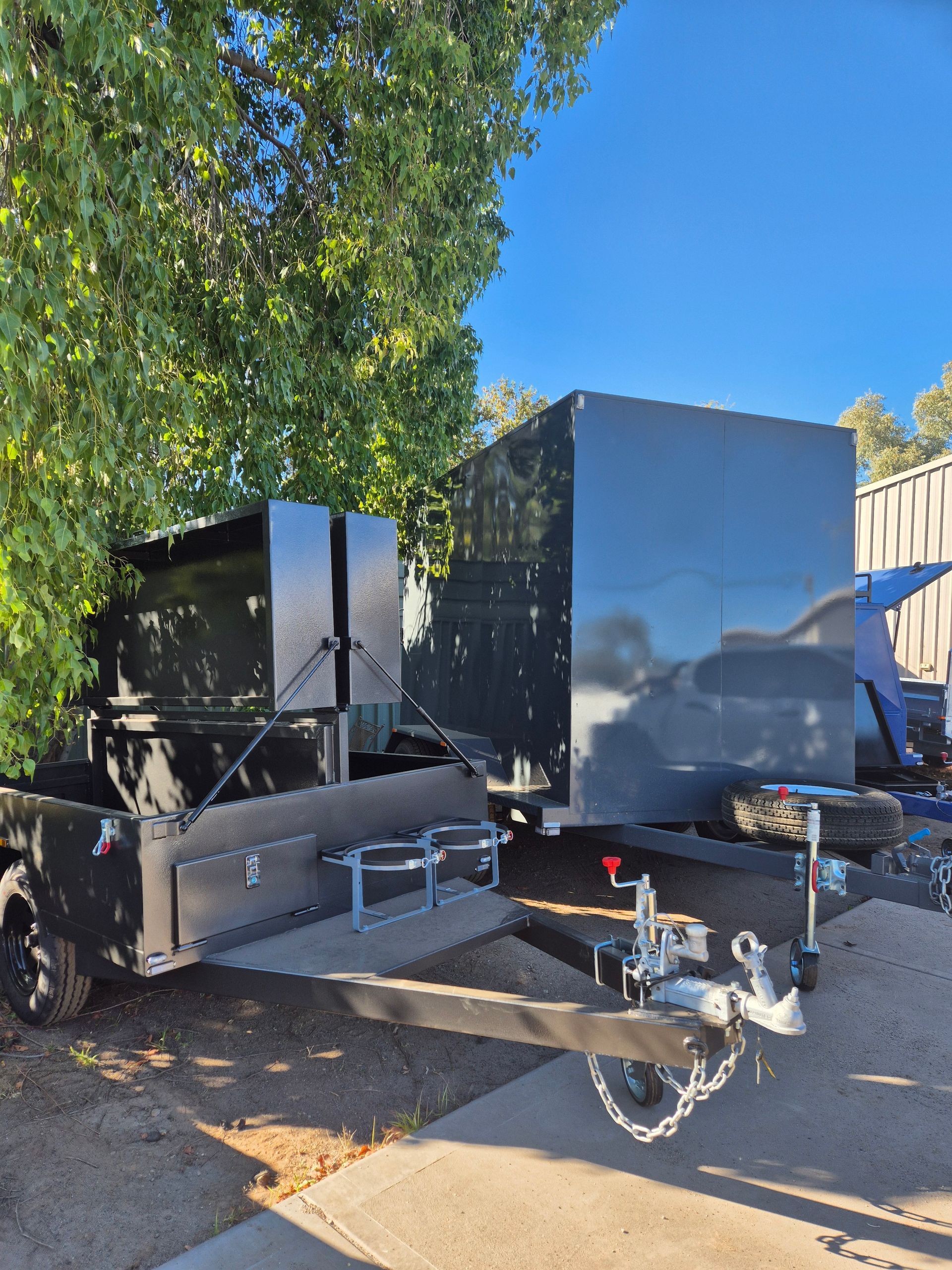 Black Utility Trailers with Metal Boxes in An Outdoor Setting — Centre Trailer Sales In Alice Springs, NT