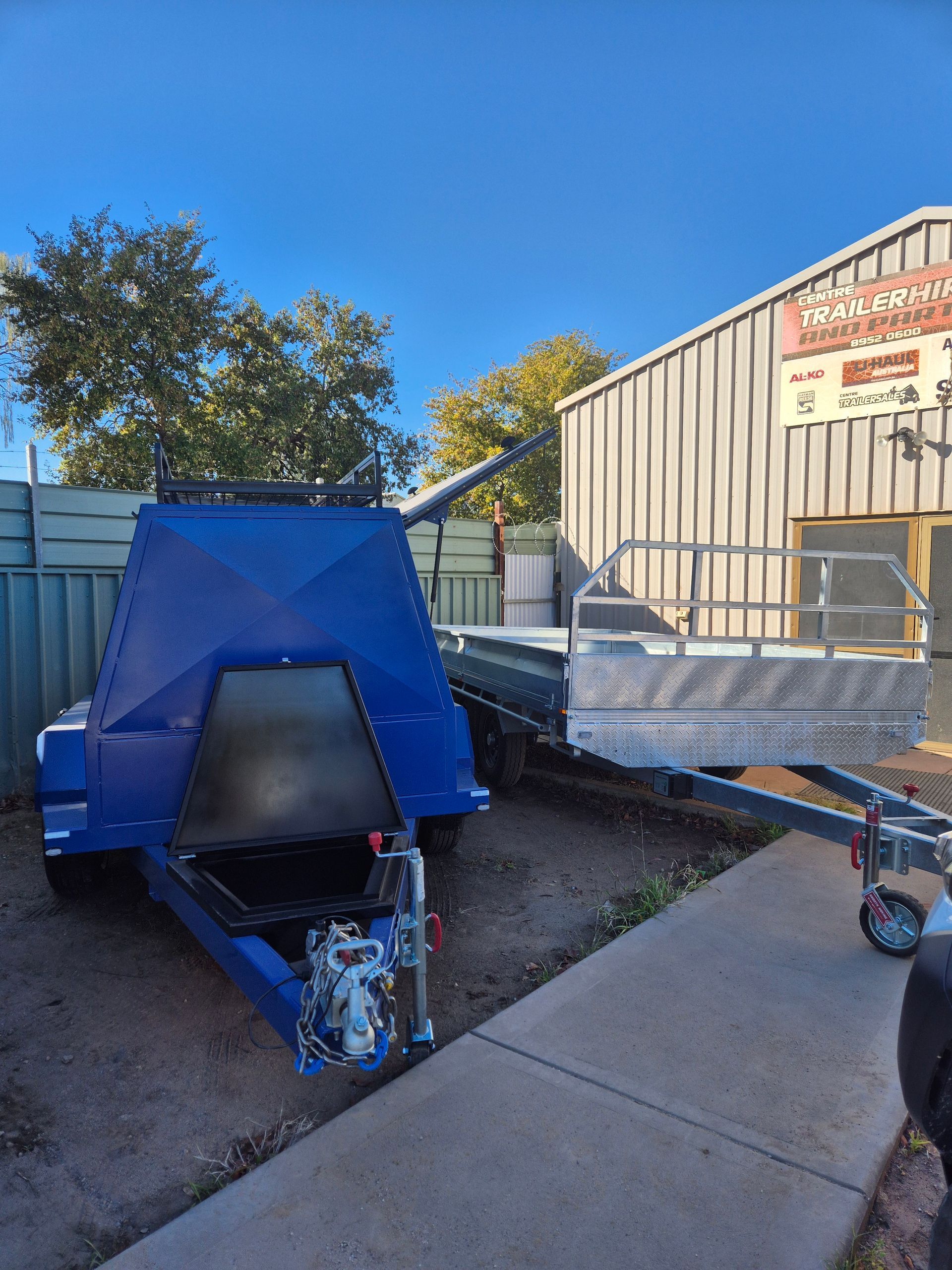 Two Trailers One Blue Camper, and One Silver Flatbed — Centre Trailer Sales In Alice Springs, NT