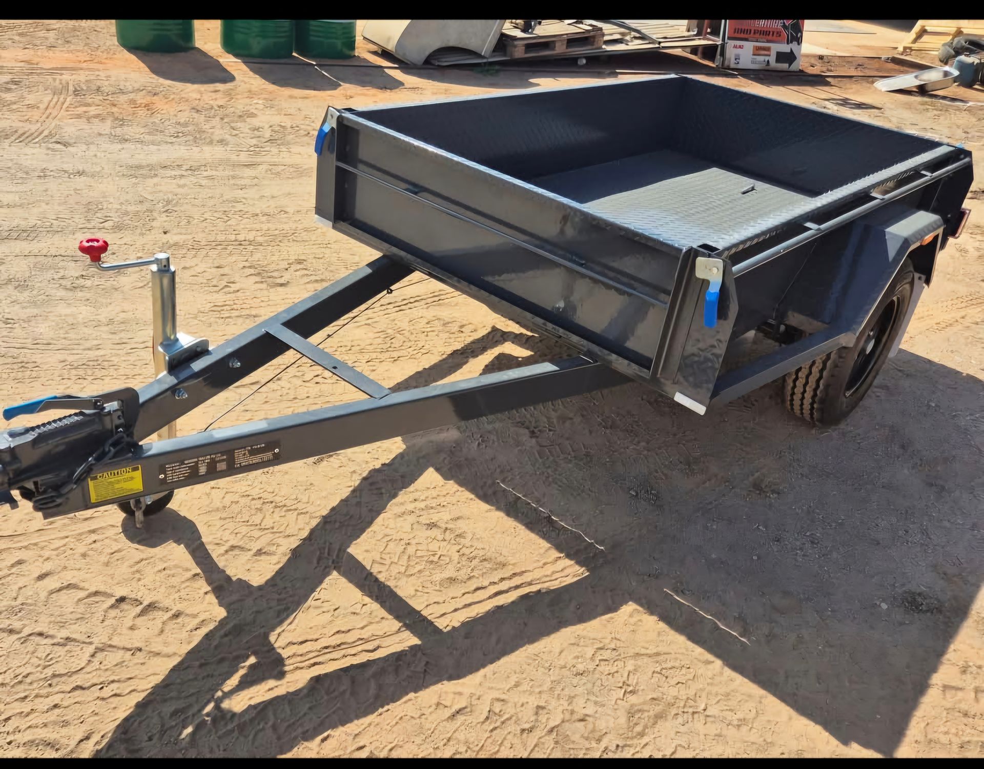 Dark Grey Utility Trailer on Dirt Angled Slightly with Raised Sides — Centre Trailer Sales In Alice Springs, NT