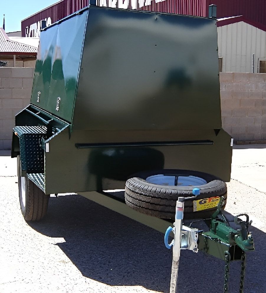 A Green Trailer Is Parked In Front Of A Building — Centre Trailer Sales In Alice Springs, NT