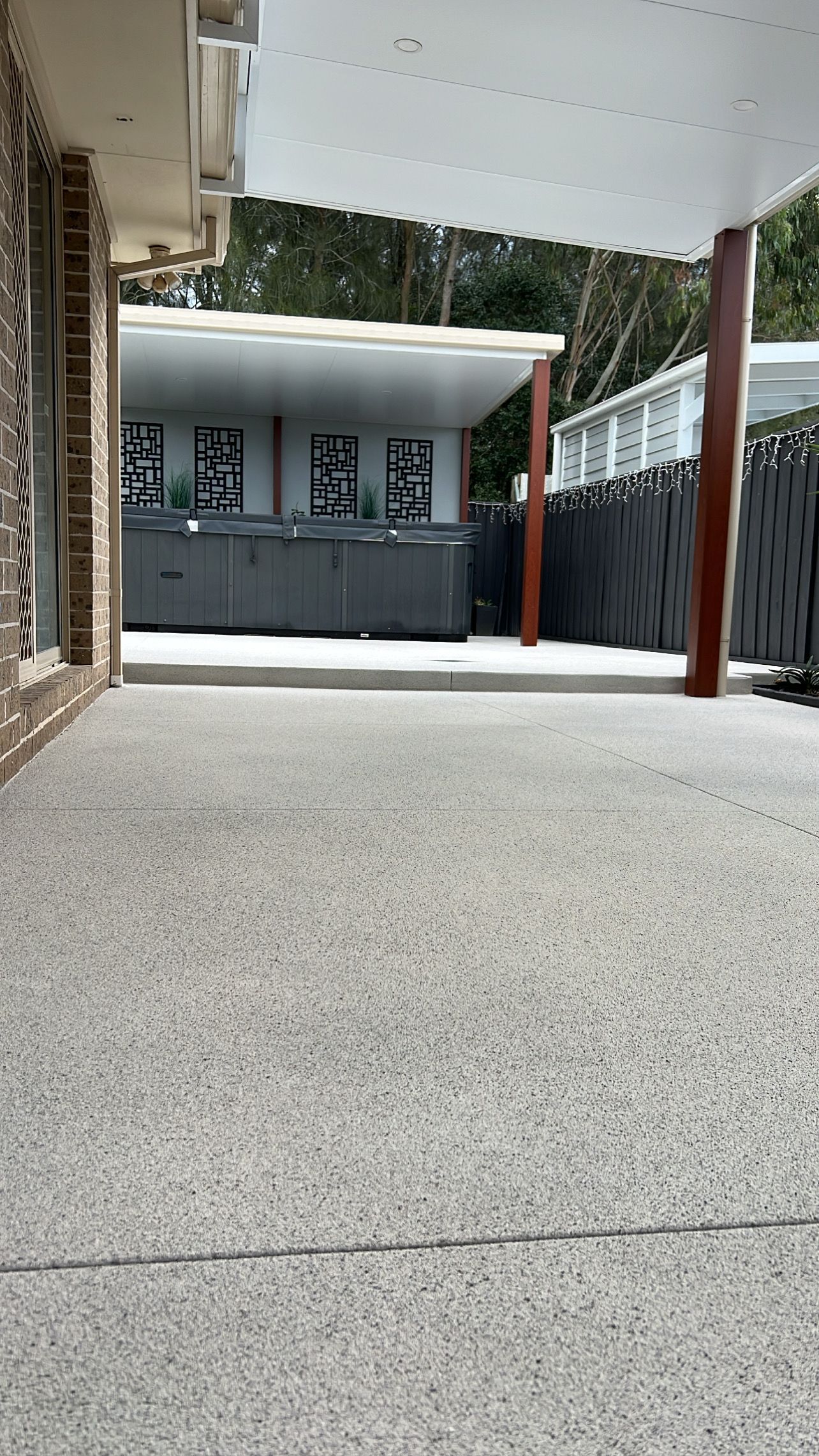 A Concrete Driveway Leading to a House With a Gazebo — Coastal Kerb and Concrete In Buff Point, NSW