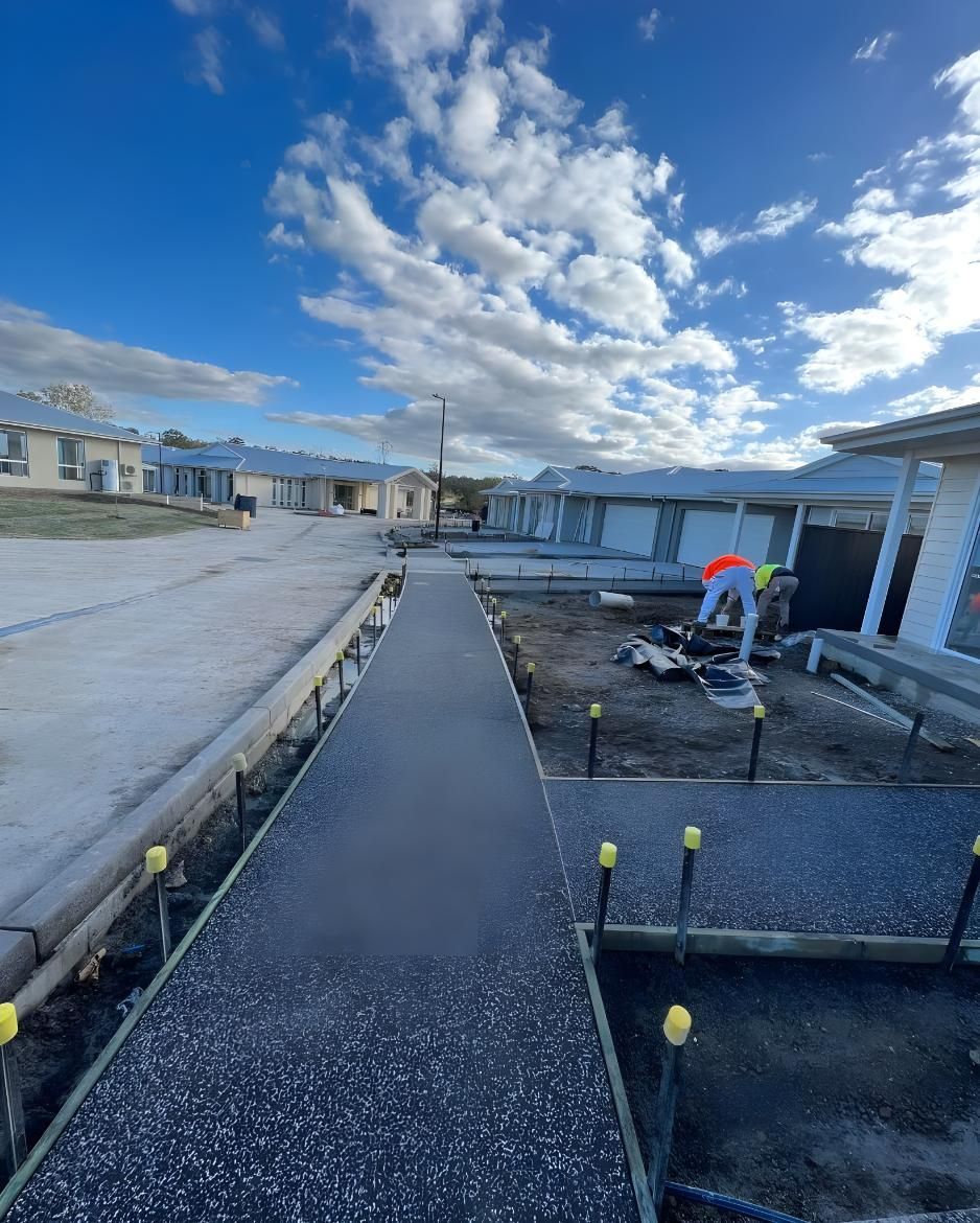 A Concrete Walkway is Being Built in a Residential Area — Coastal Kerb and Concrete In Wyee, NSW