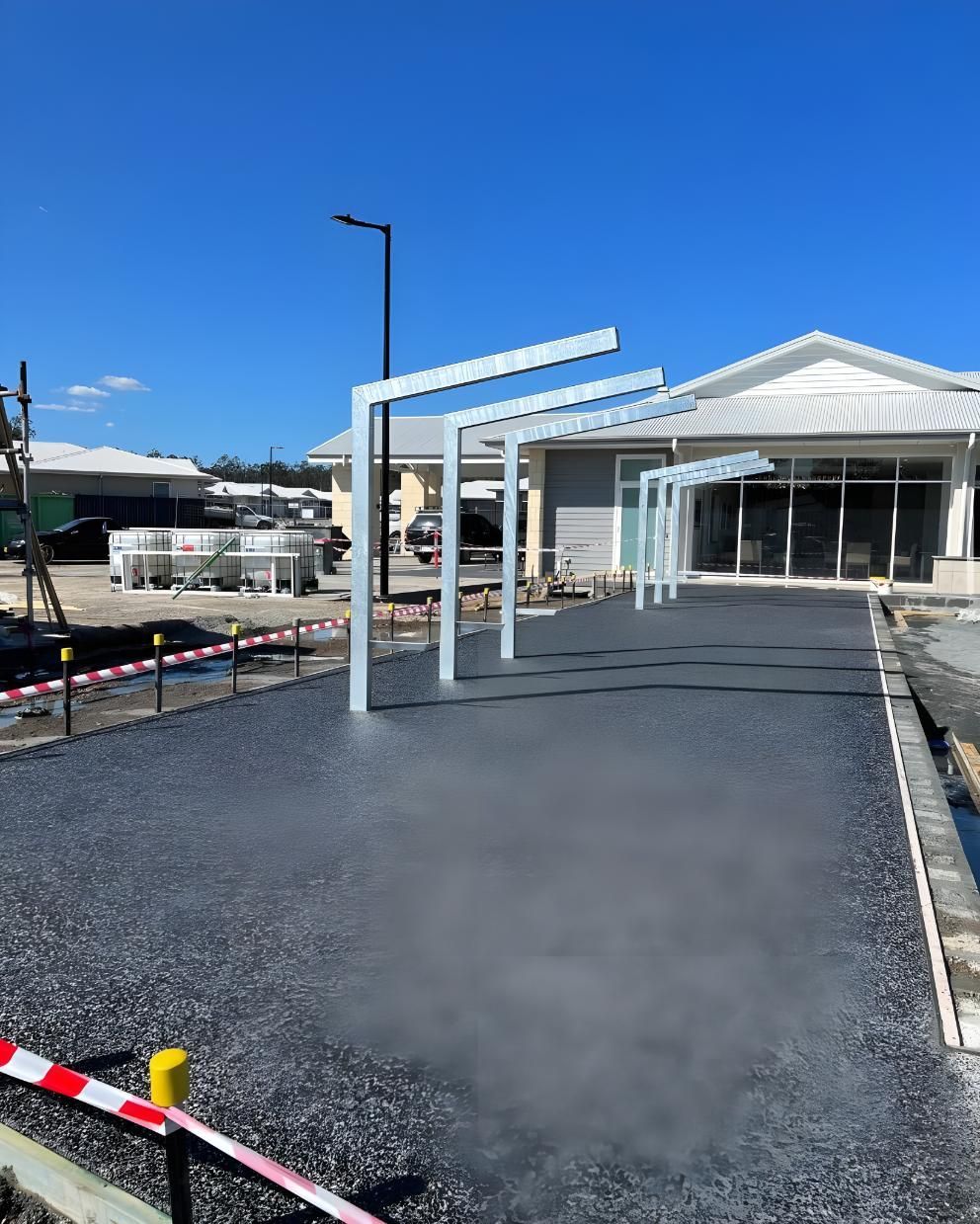 A Concrete Driveway is Being Built in Front of a House — Coastal Kerb and Concrete In Lake Macquarie, NSW