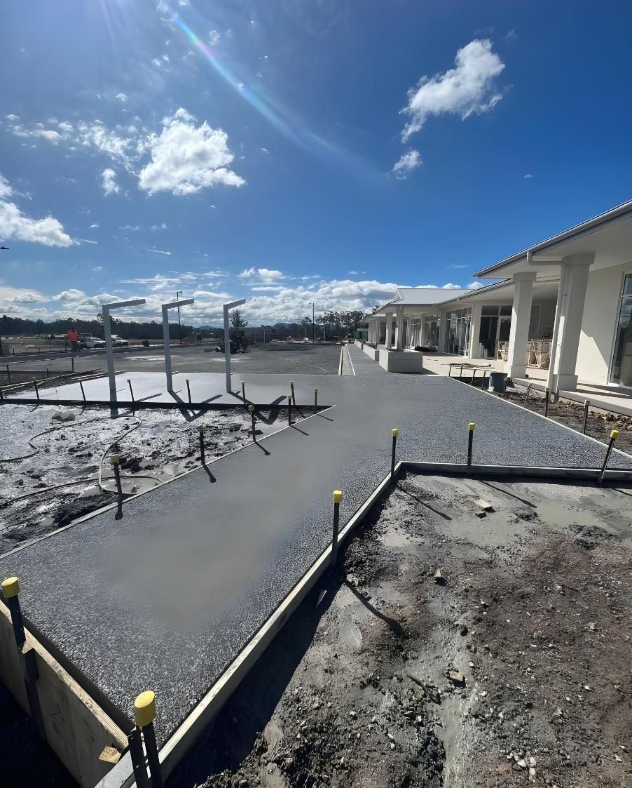 A Concrete Walkway is Being Built in Front of a House — Coastal Kerb and Concrete In Hunter Valley, NSW