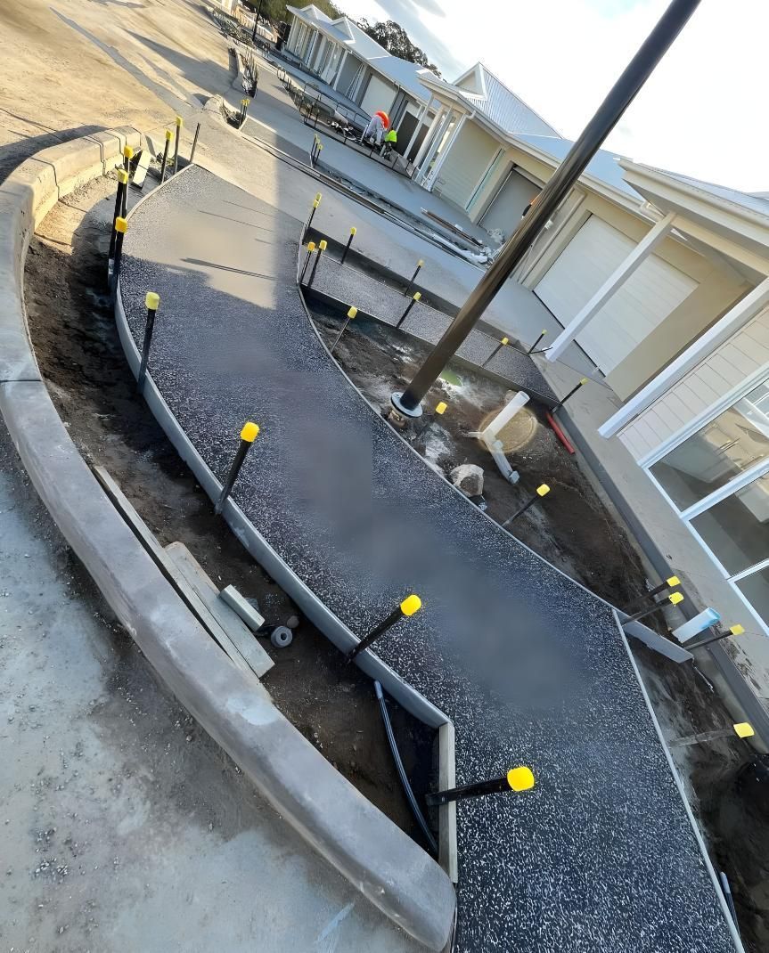 A Concrete Walkway is Being Built in Front of a House — Coastal Kerb and Concrete In Hunter Valley, NSW
