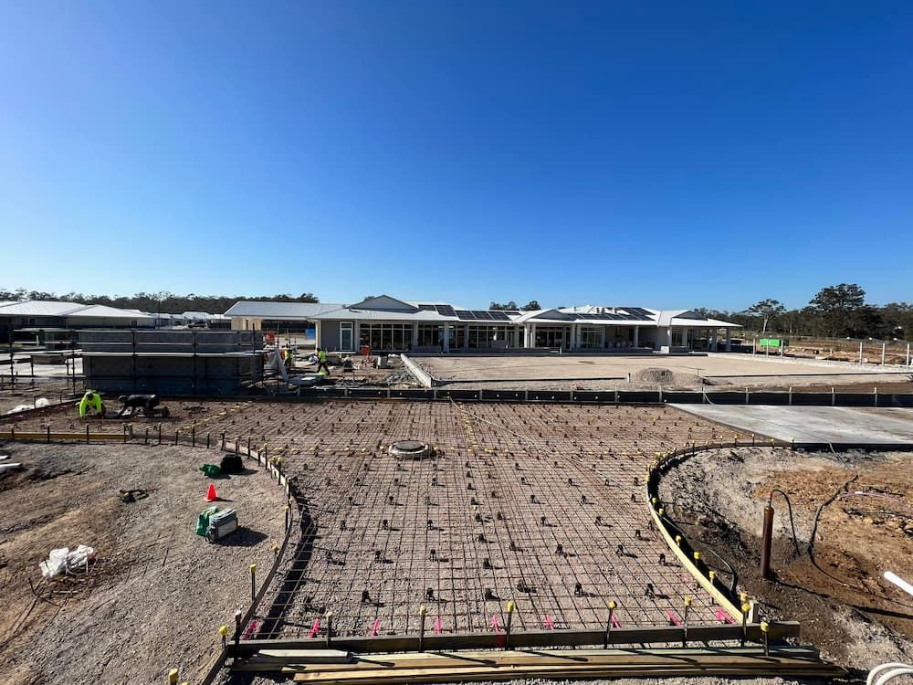 An Aerial View of a Construction Site With a Large Building in the Background — Coastal Kerb and Concrete In Buff Point, NSW