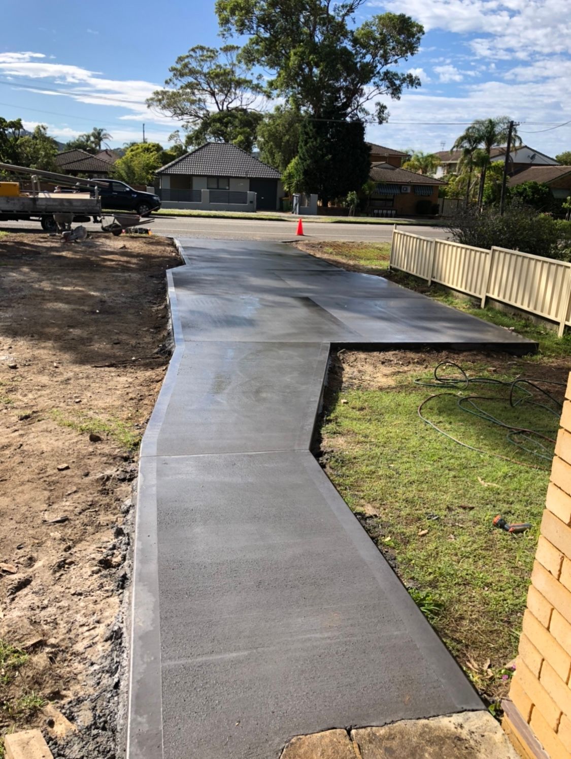 A Concrete Walkway is Being Built in Front of a House — Coastal Kerb and Concrete In Buff Point, NSW