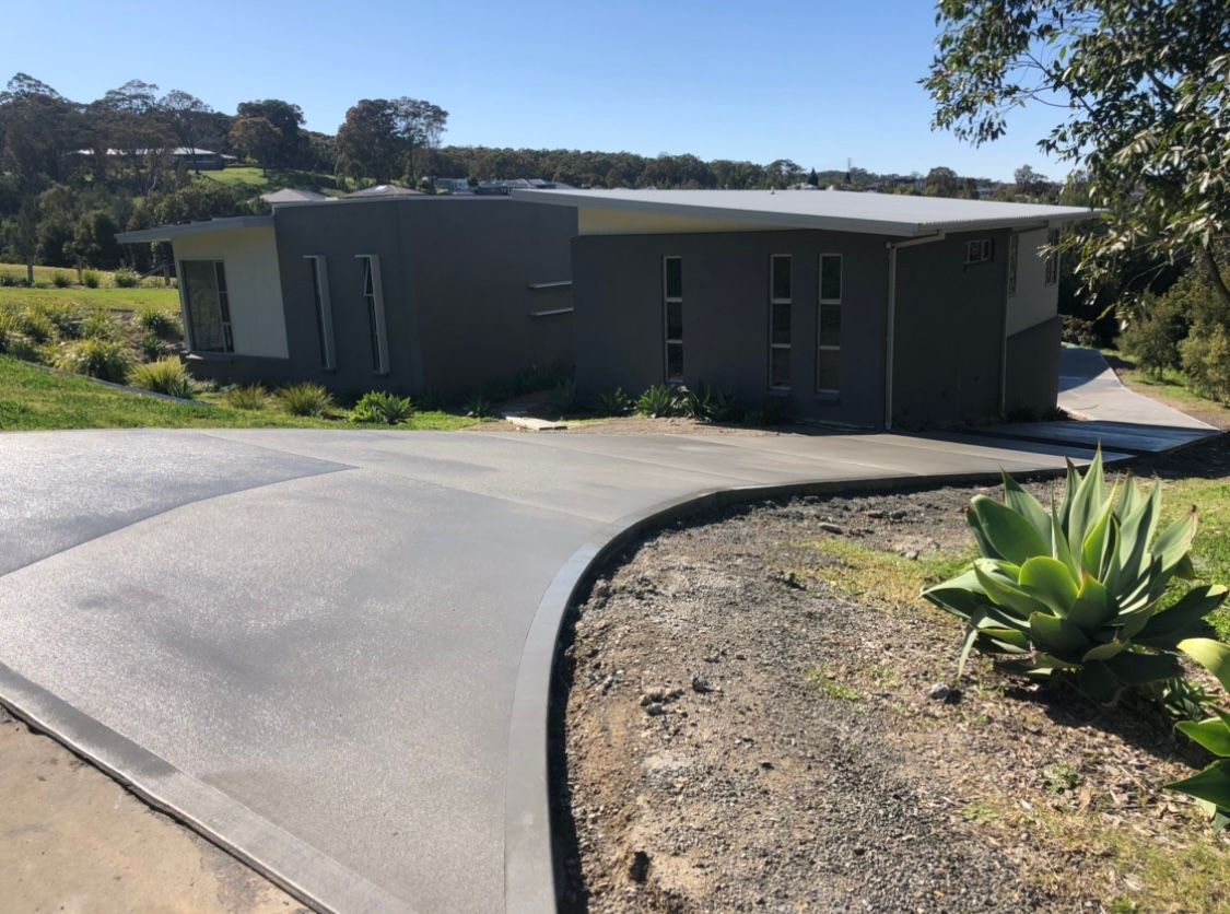 A House With a Curved Driveway Leading to It — Coastal Kerb and Concrete In Buff Point, NSW